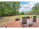 Spacious backyard deck with seating, surrounded by lush green lawn and mature trees at 100 Winterberry Ln, Holly Springs, NC 27540