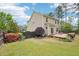 Home's backyard featuring a wooden fence, lush lawn, blooming bushes and a wooden deck at 100 Winterberry Ln, Holly Springs, NC 27540