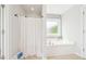 The bathroom features a soaking tub with a tiled window and a white shower curtain at 100 Winterberry Ln, Holly Springs, NC 27540