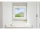 Bathroom features a white soaking tub and a decorative tiled surround window at 100 Winterberry Ln, Holly Springs, NC 27540