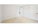 Bedroom with neutral carpet, view into hallway, and closet with double doors at 100 Winterberry Ln, Holly Springs, NC 27540