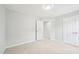 Bedroom with neutral carpet and open door with view of adjacent room at 100 Winterberry Ln, Holly Springs, NC 27540