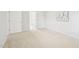 Bedroom featuring neutral carpet, white trim, a door, and geometric wall art at 100 Winterberry Ln, Holly Springs, NC 27540