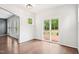 Bright dining room features hardwood floors, a slider to a deck, and trim detail at 100 Winterberry Ln, Holly Springs, NC 27540