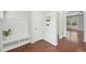 Bright foyer featuring hardwood floors, a built-in bench, and seamless transition to other rooms at 100 Winterberry Ln, Holly Springs, NC 27540