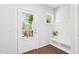 Bright foyer with a glass-paneled door, bench with storage, and views of the front yard at 100 Winterberry Ln, Holly Springs, NC 27540
