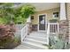 Charming front porch with decorative stone accents, white railings, and a welcoming entrance at 100 Winterberry Ln, Holly Springs, NC 27540