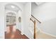 Hallway with hardwood floors, staircase, and a view of the living room, creating an open and airy feel at 100 Winterberry Ln, Holly Springs, NC 27540