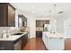 Updated kitchen features granite counters, stainless appliances, and dark cabinets at 100 Winterberry Ln, Holly Springs, NC 27540