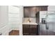Kitchen pantry and refrigerator with gray backsplash and lots of storage at 100 Winterberry Ln, Holly Springs, NC 27540