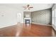 Spacious living room with hardwood floors, a decorative accent wall, and a cozy fireplace at 100 Winterberry Ln, Holly Springs, NC 27540