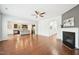 Open-concept living room with hardwood floors, fireplace, and seamless flow to the kitchen, ideal for entertaining at 100 Winterberry Ln, Holly Springs, NC 27540