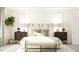 Comfortable main bedroom with elegant lamps, side tables, decorative pillows, and a bench with sunlight at 1012 Red Roses Ave, Durham, NC 27703