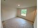 A bright bedroom with a window overlooking the landscape, perfect for relaxation at 1031 Mountain Crown St, Durham, NC 27703