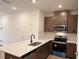 A well-equipped kitchen featuring stainless steel appliances, cabinetry and quartz countertops at 1031 Mountain Crown St, Durham, NC 27703