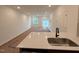 Bright living room with sliding glass doors with luxury vinyl plank flooring and a kitchen island at 1031 Mountain Crown St, Durham, NC 27703