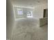 View of a large, open room with concrete floors, white walls, and abundant natural light at 1031 Mountain Crown St, Durham, NC 27703