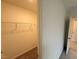 A wide walk-in closet with shelving for storage for a well-organized wardrobe at 1031 Mountain Crown St, Durham, NC 27703