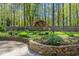 Backyard garden with stone retaining wall and colorful flowers and lush landscaping at 10609 Lowery Dr, Raleigh, NC 27615