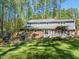 A landscaped backyard features a patio with seating and an outdoor dining area at 10609 Lowery Dr, Raleigh, NC 27615