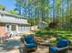 Backyard view of the house with brick patio, outdoor seating, shed and landscaped flower garden at 10609 Lowery Dr, Raleigh, NC 27615