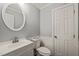 Bathroom featuring a toilet, sink vanity and white wainscoting at 10609 Lowery Dr, Raleigh, NC 27615
