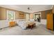 Inviting bedroom with a quilted bedspread, natural light, and light brown walls at 10609 Lowery Dr, Raleigh, NC 27615