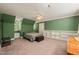 Spacious bedroom showcasing built-in shelving, green walls, carpet, and natural light, creating a serene retreat at 10609 Lowery Dr, Raleigh, NC 27615