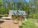 Traditional brick home with manicured lawn, mature trees and detailed landscaping create curb appeal at 10609 Lowery Dr, Raleigh, NC 27615