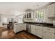 The kitchen features white cabinets, modern appliances, and an adjacent dining area at 10609 Lowery Dr, Raleigh, NC 27615