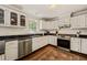 Bright kitchen features white cabinets, stainless appliances, and dark countertops at 10609 Lowery Dr, Raleigh, NC 27615
