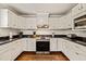Well-appointed kitchen with stainless appliances and stylish black countertops at 10609 Lowery Dr, Raleigh, NC 27615