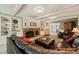 Cozy living room with brick fireplace, built-in shelves, and comfortable leather furniture at 10609 Lowery Dr, Raleigh, NC 27615
