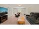 Comfortable living room with plush seating, natural light, and neutral carpet, perfect for relaxation and entertainment at 10609 Lowery Dr, Raleigh, NC 27615