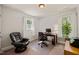 Bright home office with two windows, an executive chair and a desk at 10609 Lowery Dr, Raleigh, NC 27615
