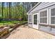 Exterior view of a gray house with brick patio, steps and flower garden at 10609 Lowery Dr, Raleigh, NC 27615