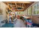 A shed with exposed beams and brick floor, with lots of storage capacity and natural light at 10609 Lowery Dr, Raleigh, NC 27615