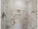 Modern shower featuring marble-patterned tile and a built-in niche for toiletries at 10609 Lowery Dr, Raleigh, NC 27615