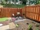 Private fenced backyard with gravel, a table and chairs, and lush greenery at 10943 Pendragon Pl, Raleigh, NC 27614