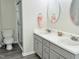 Bathroom with double vanity sinks and a glass-enclosed shower at 10943 Pendragon Pl, Raleigh, NC 27614