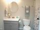 Well-lit bathroom with a classic vanity, toilet, and shower with a curtain at 10943 Pendragon Pl, Raleigh, NC 27614