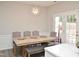 A dining room with a large table, chairs, and a bench, illuminated by a chandelier at 10943 Pendragon Pl, Raleigh, NC 27614