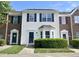 Charming townhouse featuring a well-manicured front lawn and inviting front door at 10943 Pendragon Pl, Raleigh, NC 27614