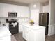 A kitchen featuring white cabinetry, stainless steel appliances, and marble countertops at 10943 Pendragon Pl, Raleigh, NC 27614