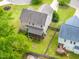 Aerial view of a two-story home with a screened porch, fire pit, and green lawn, surrounded by mature trees at 11 Glen Valley Ct, Angier, NC 27501