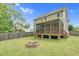 Backyard with a firepit and view of the covered porch at 11 Glen Valley Ct, Angier, NC 27501