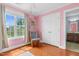 A pink-themed room with a rocking chair, closet, and a view of the backyard at 11 Glen Valley Ct, Angier, NC 27501