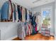 A full walk-in closet with shelving, rods, and a window for natural light at 11 Glen Valley Ct, Angier, NC 27501