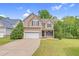 Traditional two-story home featuring a spacious driveway, lush lawn, and well-maintained landscaping at 11 Glen Valley Ct, Angier, NC 27501