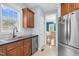 A portion of the kitchen with stainless steel appliances, wood cabinetry, and a view into the dining room at 11 Glen Valley Ct, Angier, NC 27501